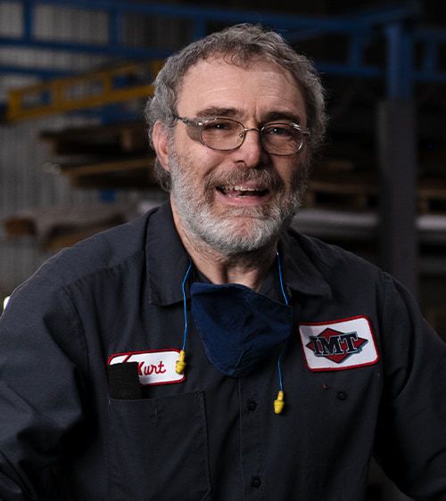 Iowa Mold Tooling employee smiling at the camera.