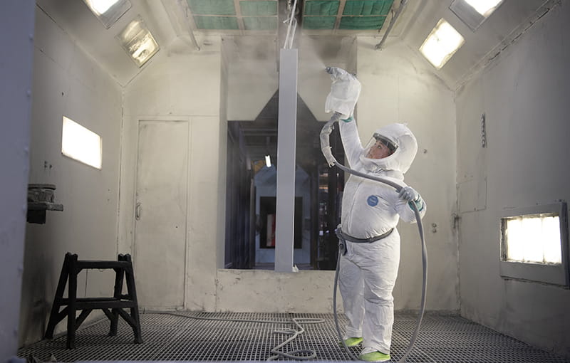 An Employee Working In The Paint Department Wearing Personal Protective Equipment.